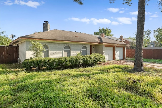 ranch-style home with a front yard and a garage