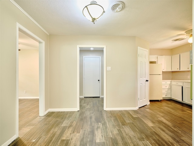 interior space featuring a textured ceiling, ceiling fan, and light hardwood / wood-style floors