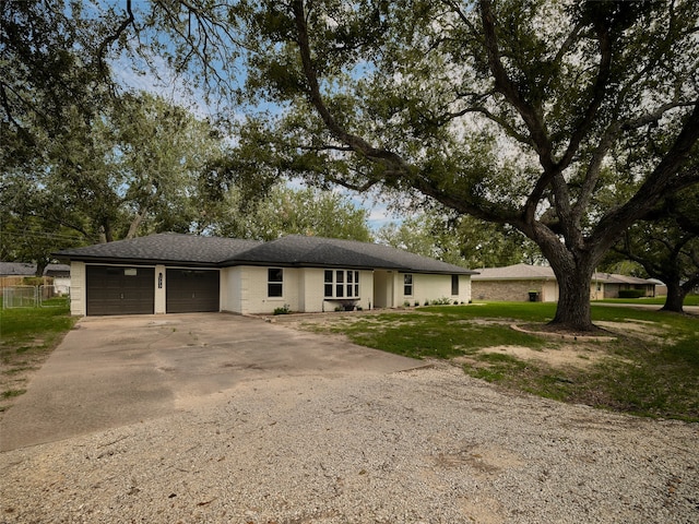 ranch-style home featuring a garage and a front yard