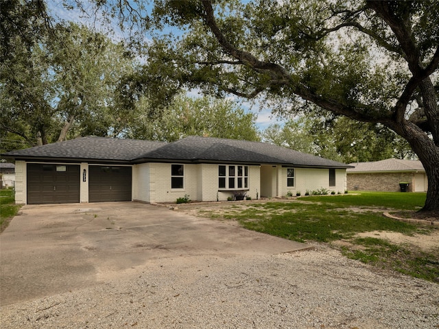 single story home with a garage and a front yard