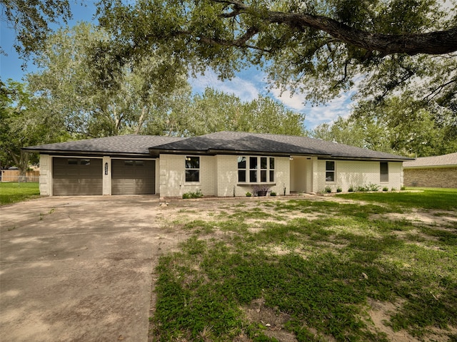 view of front of home featuring a garage and a front lawn