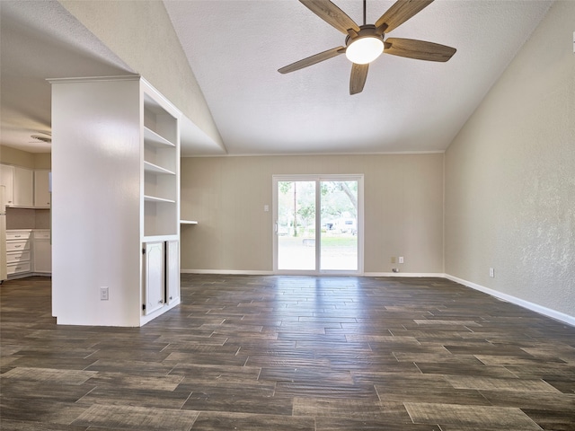 empty room with lofted ceiling, dark wood-type flooring, ceiling fan, and a textured ceiling