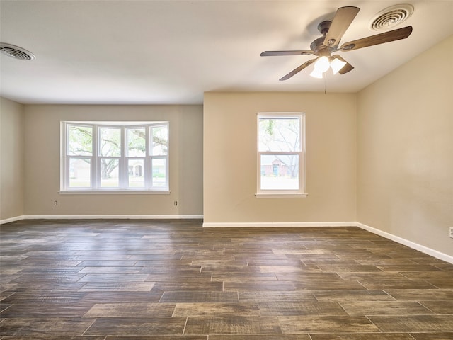 unfurnished room featuring dark wood-type flooring and ceiling fan