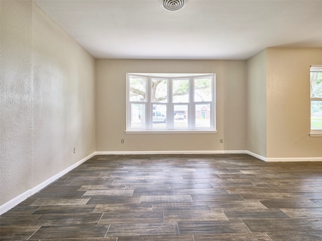 spare room with dark hardwood / wood-style floors