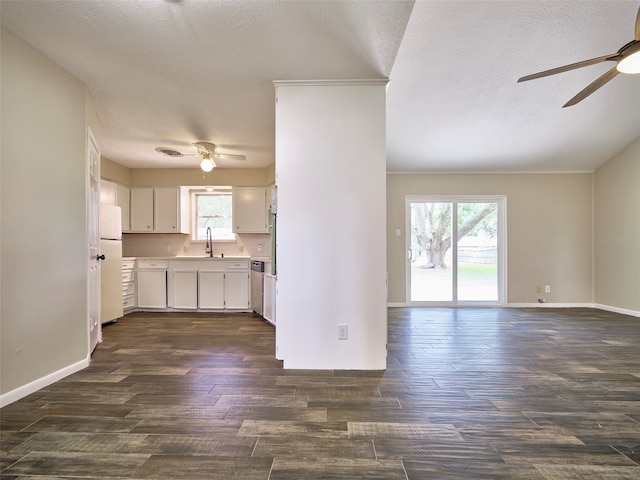 kitchen with dark wood-type flooring, ceiling fan, a wealth of natural light, and white fridge