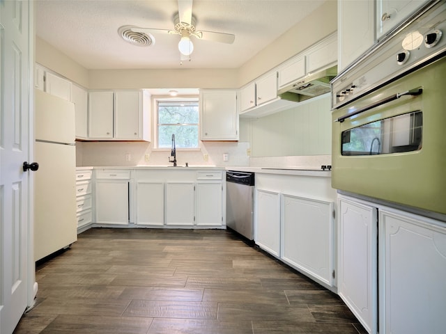 kitchen with appliances with stainless steel finishes, white cabinetry, ceiling fan, and dark hardwood / wood-style floors