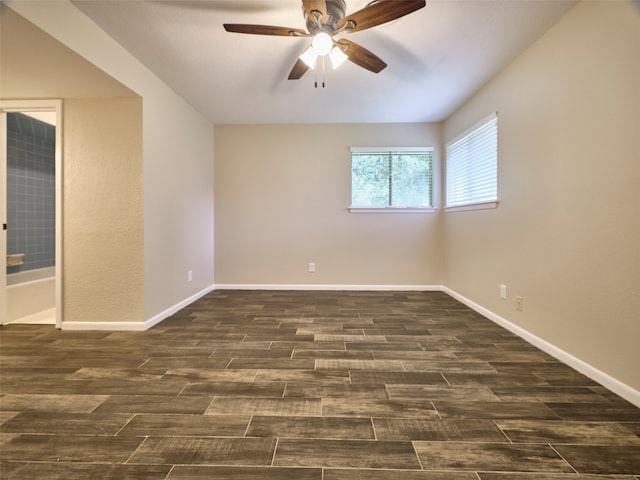 unfurnished room with ceiling fan and dark hardwood / wood-style flooring