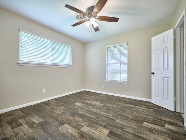 spare room featuring ceiling fan and dark hardwood / wood-style flooring