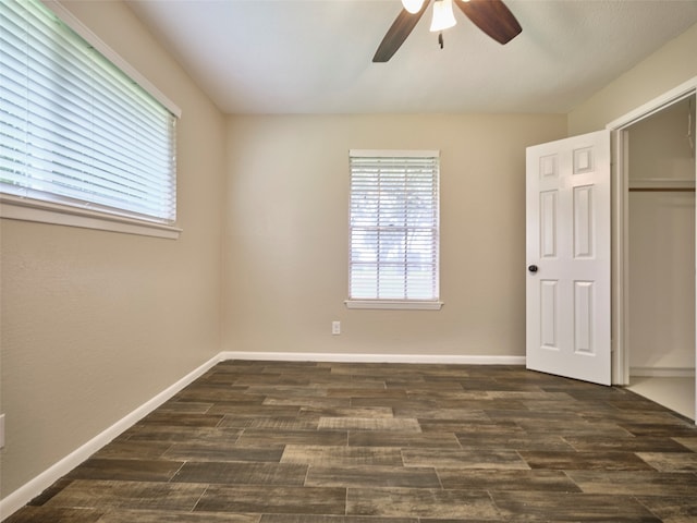 unfurnished bedroom featuring ceiling fan and dark hardwood / wood-style floors