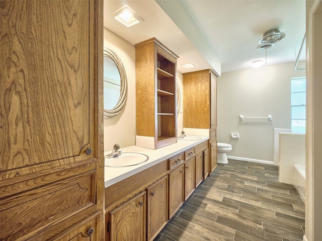 bathroom featuring vanity, toilet, a bathtub, and wood-type flooring