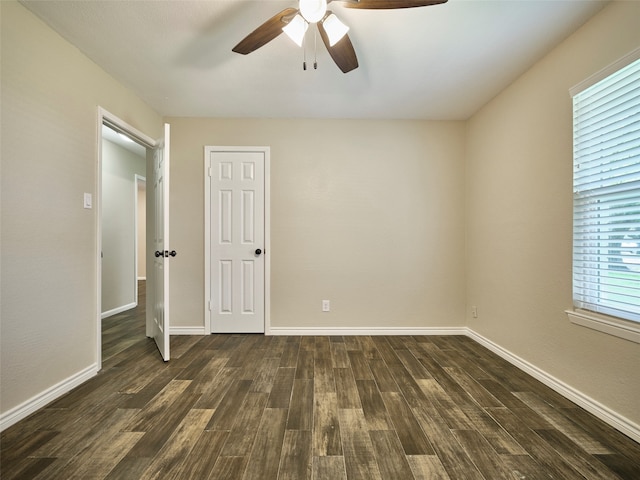 unfurnished bedroom featuring ceiling fan and dark hardwood / wood-style flooring