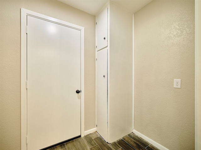 doorway with dark wood-type flooring