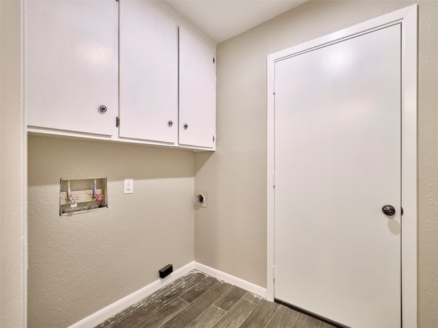 washroom featuring dark wood-type flooring, cabinets, washer hookup, and hookup for an electric dryer