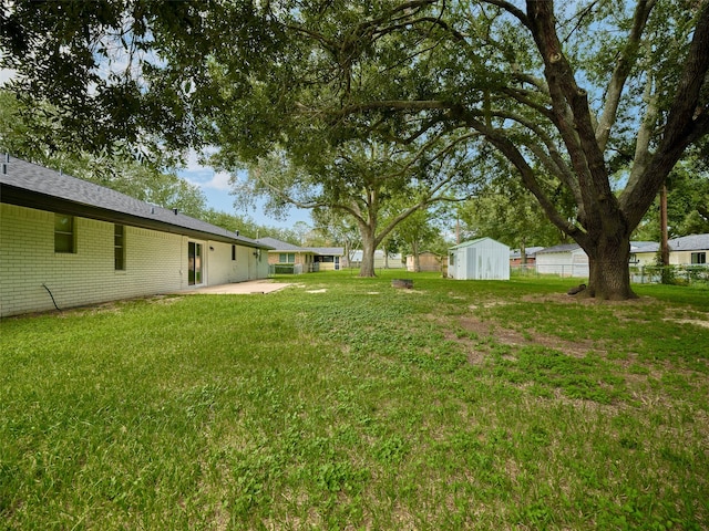 view of yard with a patio area and a shed