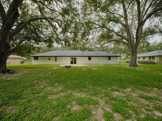 back of house with a yard