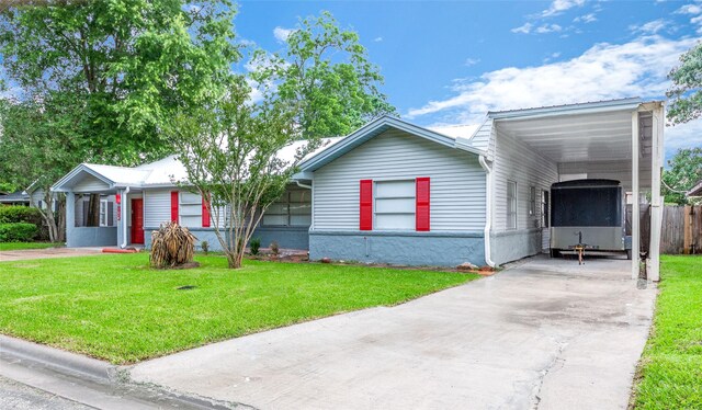 ranch-style home with a front yard and a carport