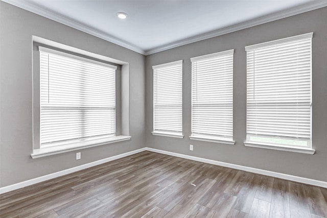 unfurnished room with crown molding and light hardwood / wood-style flooring