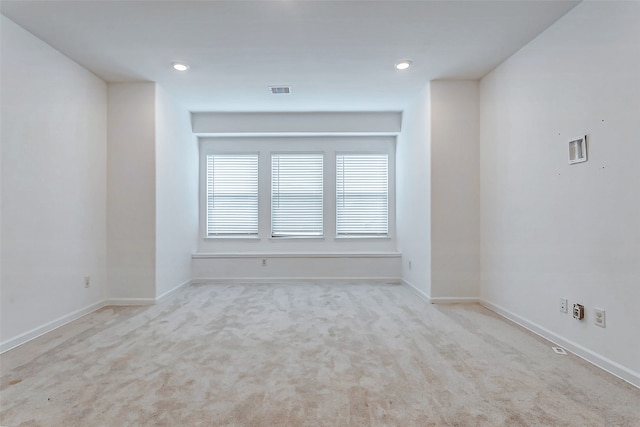 spare room with light colored carpet