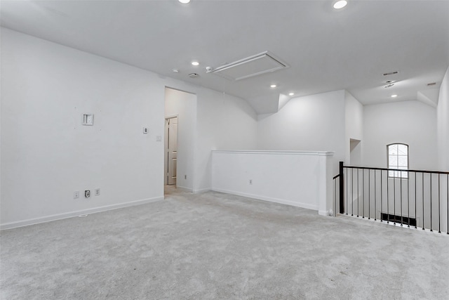 carpeted spare room with lofted ceiling