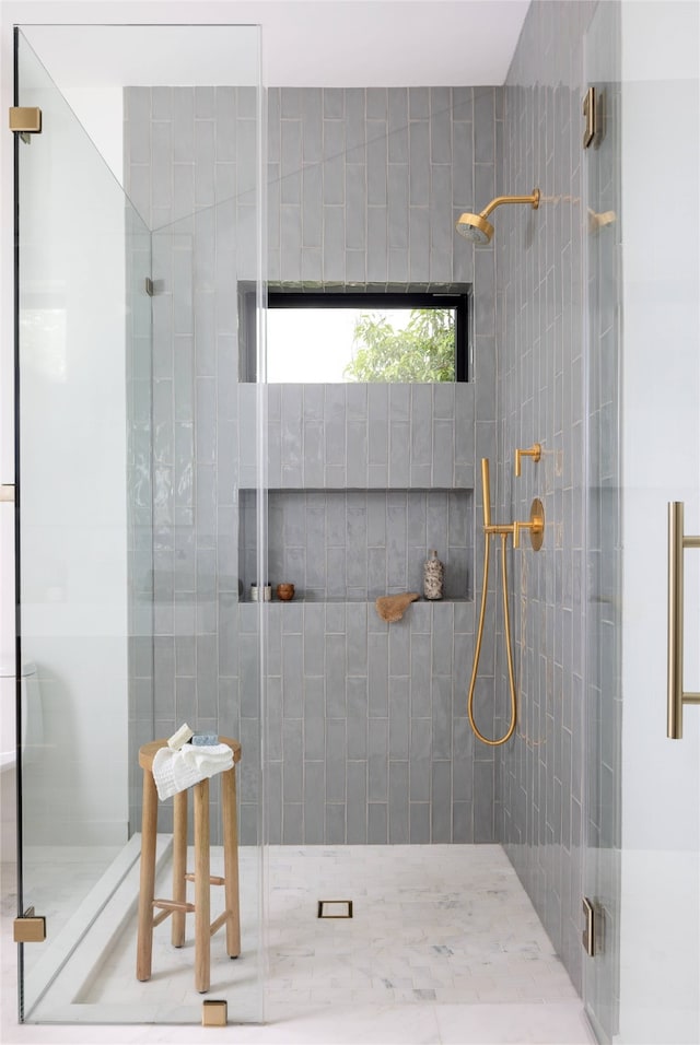 bathroom with a shower with shower door