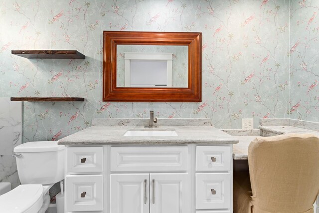 bathroom with vanity and toilet