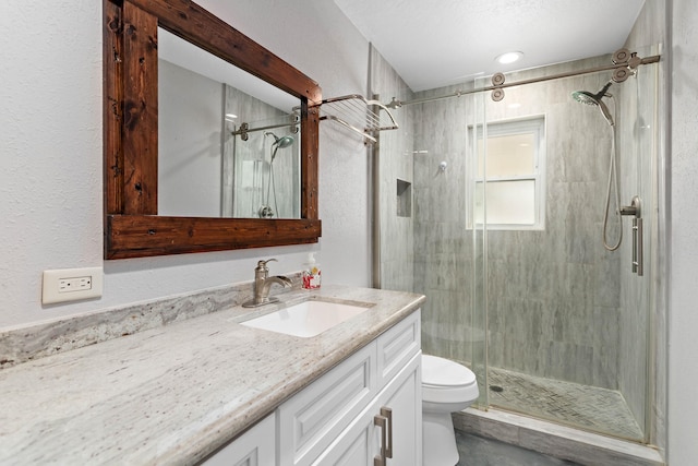 bathroom featuring vanity, toilet, and walk in shower