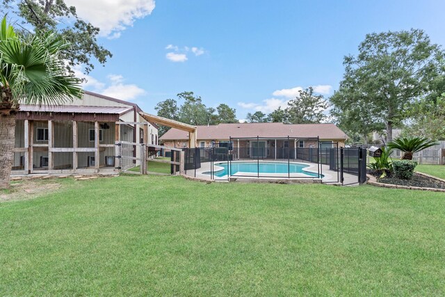 view of pool with a yard