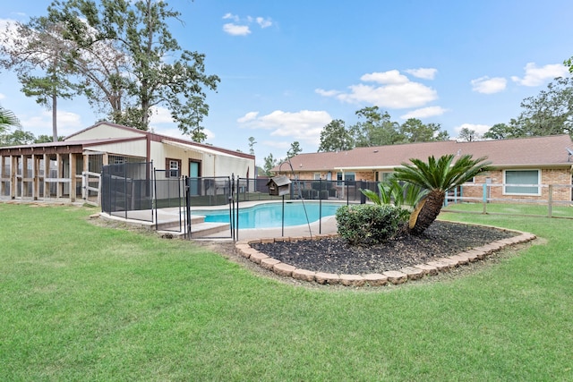 view of swimming pool with a lawn