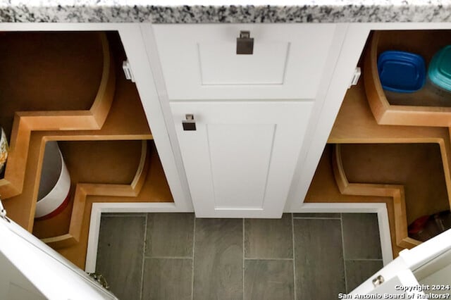 interior space featuring wood-type flooring and white cabinets