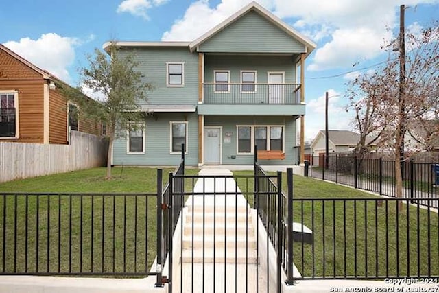 view of front of property with a balcony and a front yard