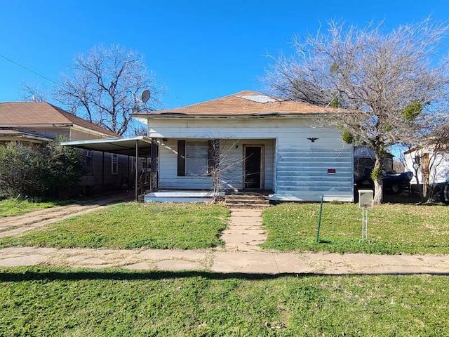 bungalow-style house with a front lawn