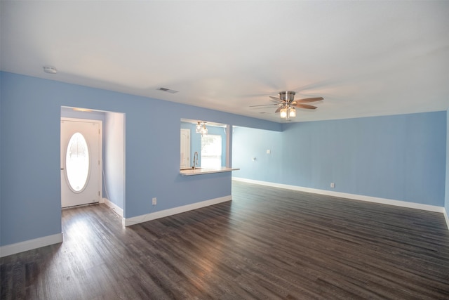 interior space featuring dark hardwood / wood-style floors, ceiling fan, and sink