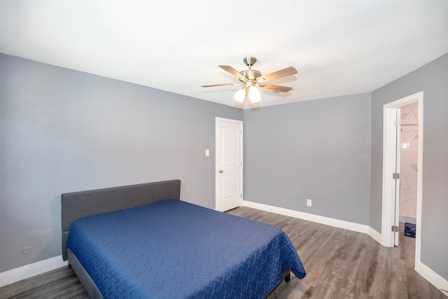 bedroom featuring connected bathroom, dark hardwood / wood-style floors, and ceiling fan