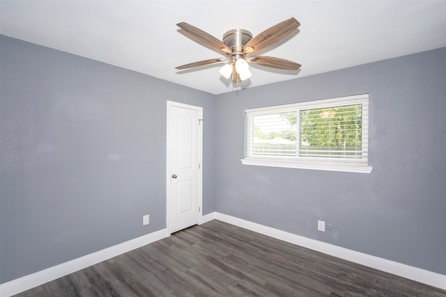 empty room with ceiling fan and dark hardwood / wood-style floors