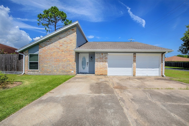 view of front of property with a front yard and a garage