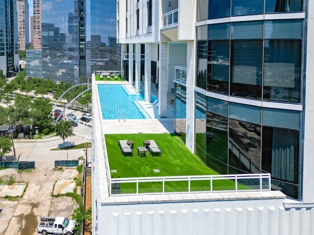 view of swimming pool featuring a patio area and a lawn