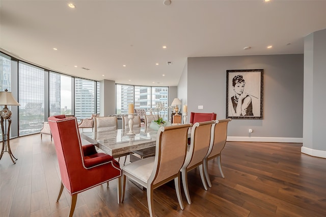 dining area featuring a wall of windows and wood-type flooring