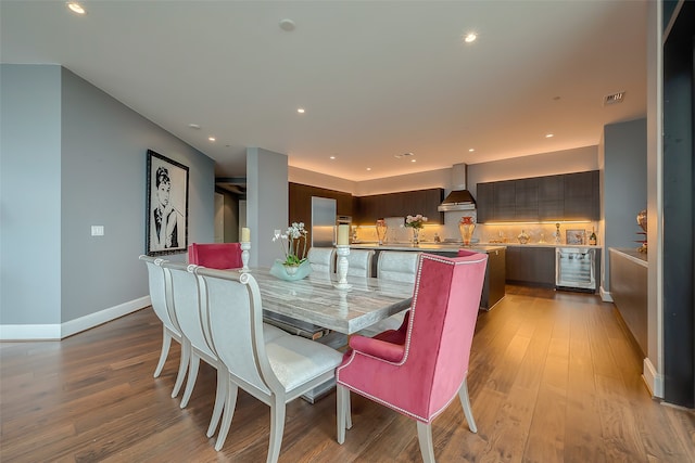 dining room featuring wine cooler and light hardwood / wood-style floors