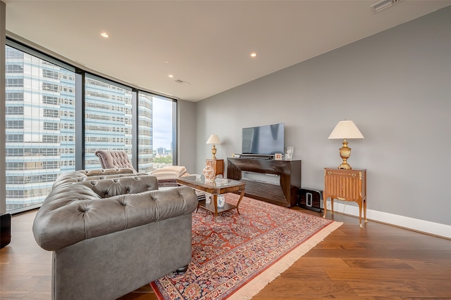 living room with hardwood / wood-style floors and floor to ceiling windows