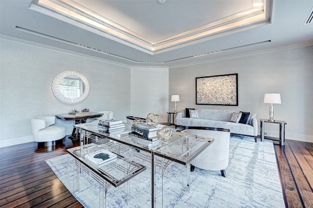 living room with crown molding, a raised ceiling, and wood-type flooring