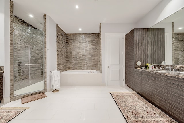 bathroom with plus walk in shower, tile patterned flooring, and vanity