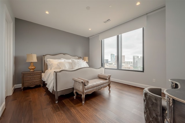 bedroom with dark hardwood / wood-style floors