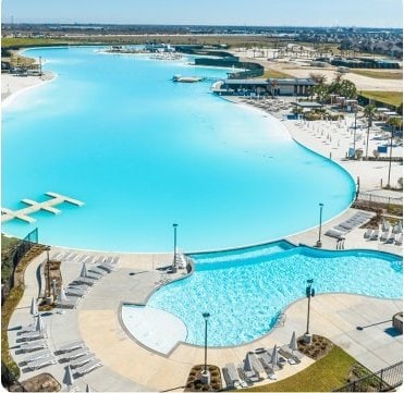 view of swimming pool featuring a water view and a patio area