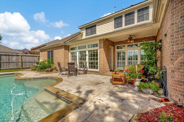 back of property with a fenced in pool, ceiling fan, and a patio