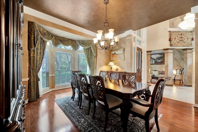 dining space with hardwood / wood-style floors and an inviting chandelier