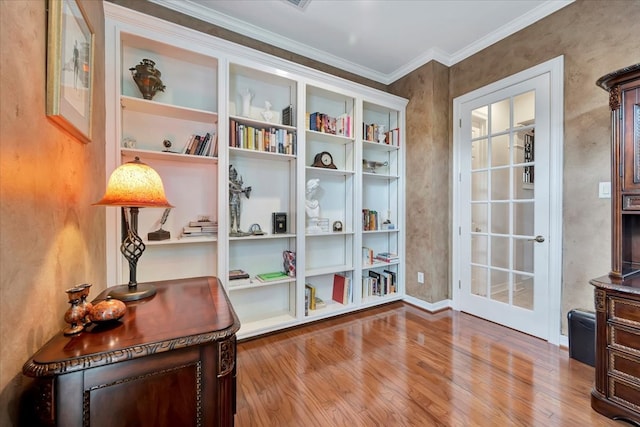 sitting room featuring light wood-type flooring and ornamental molding