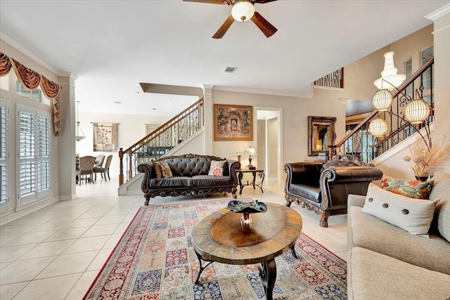 tiled living room with ornamental molding and ceiling fan