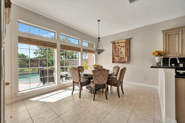 dining space featuring ornamental molding, a healthy amount of sunlight, and light tile patterned floors