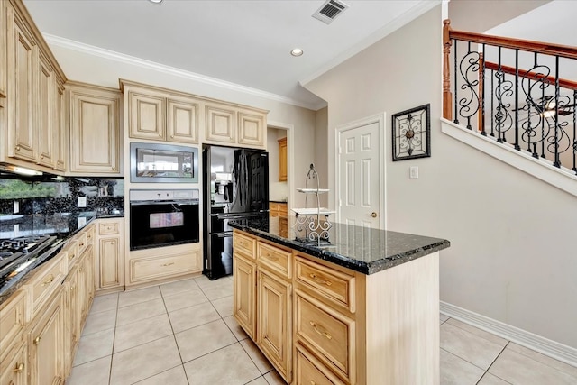 kitchen featuring dark stone countertops, light tile patterned floors, a center island, black appliances, and decorative backsplash