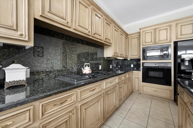 kitchen with black appliances, dark stone countertops, light tile patterned floors, and crown molding